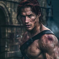 a man with red hair and no shirt on in the rain wearing a leather harness