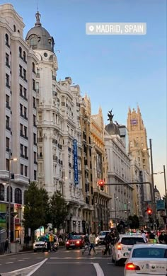 a city street filled with traffic and tall buildings