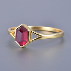 This exquisite ruby ring is a perfect blend of timeless elegance and modern design. Featuring a unique hexagon-cut ruby, this solitaire ring is crafted with a vintage bezel setting in solid 14k yellow gold. The vibrant red hue of the ruby is beautifully complemented by the warm glow of the gold, making it a stunning piece for any occasion. Whether it's an engagement, anniversary, or a special gift, this ring is designed to make a lasting impression. The sophisticated bezel setting not only enhan Ruby Bezel Ring, Ruby Ring Vintage, Bezel Engagement Ring, Ruby Engagement Ring, Engagement Anniversary, Ring Unique, Yellow Gold Ring, Ruby Ring, Ring Vintage