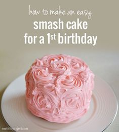 a pink cake sitting on top of a white plate with the words first birthday smash cake recipe