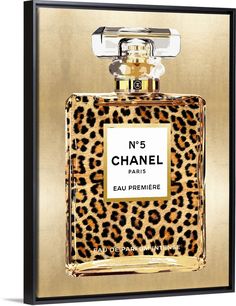 a bottle of chanel leopard print perfume in gold and black framed on a white background