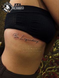 a woman's stomach with the words be legend written on it and an arrow tattoo