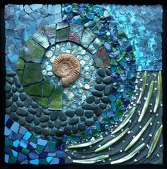 this is a mosaic art work made with stones and glass tiles, including a shell