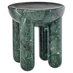 a green marble side table with three legs