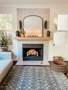 a living room with a fire place in the middle and a rug on the floor