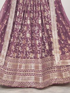 This purple jacquard lehenga ensemble, adorned with intricate zari embroidery and dazzling sequin work. The majestic hue of purple radiates sophistication and allure, making it an ideal choice for weddings, festivities, and special occasions. Crafted from luxurious jacquard fabric, the lehenga boasts a semi-stitched design, offering a comfortable fit of up to 42 inches while allowing freedom of movement.
Accompanying the lehenga is a matching jacquard choli, intricately embellished with zari emb Semi-stitched Purple Sharara With Resham Embroidery, Purple Salwar Kameez With Intricate Embroidery For Navratri, Festive Purple Embroidered Sharara, Festive Embroidered Purple Sharara, Purple Dola Silk Dupatta With Intricate Embroidery, Festival Purple Salwar Kameez With Intricate Embroidery, Unstitched Purple Traditional Wear For Reception, Purple Sharara With Resham Embroidery For Festivals, Designer Traditional Wear With Intricate Embroidery In Purple