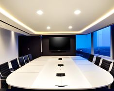 an empty conference room with a flat screen tv