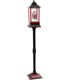 a red and black post with a christmas lantern on it's top, in front of a white background