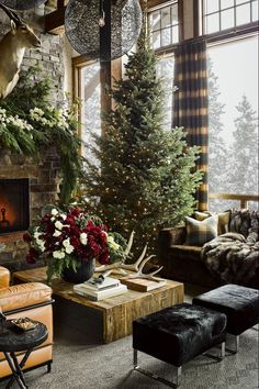 a living room filled with furniture and a christmas tree in front of a fire place