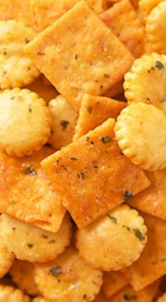 close up view of cheesy crackers with seasoning on them in a bowl