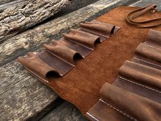 a brown leather case sitting on top of a wooden table