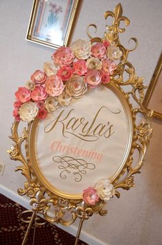 an ornate gold frame with pink flowers on it