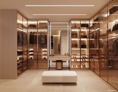 a large walk in closet with lots of shoes on the shelves and footstools