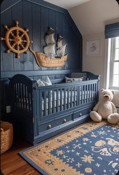 a baby crib with a teddy bear sitting in it next to a rug on the floor