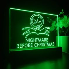 a neon sign that says nightmares before christmas with an image of a skull on it