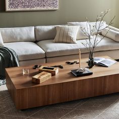 a living room filled with furniture and a wooden coffee table