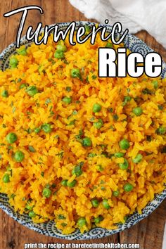 a bowl filled with rice and peas on top of a wooden table