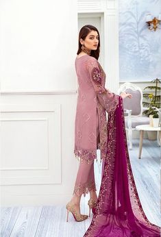 The new party and festive wear collection is geared up with embroidered Pakistani chiffon dress online . You can buy lavish fancy wear online to adorn your special event look in an elegant way. Shirt: This lavish attire is highlighting its grace with lilac color embroidered panels for shirt. Chiffon shirt is embellished with sequins embroidered work in beautiful patterns. Sleeves, Front and front back of shirt are embellished with tissue embroidered borders. Trouser: This Pakistani chiffon dress Chiffon Suit, Eid Dress, Pakistani Dresses Online, Chiffon Party Dress, Dress Traditional, Pakistani Suit, Culture Fashion, Salwar Kamiz, Pakistani Salwar Kameez