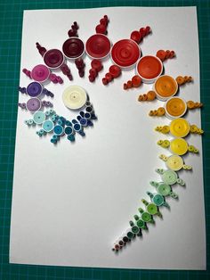 several different colored buttons are arranged on a piece of paper