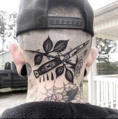 the back of a man's head with tattoos on it