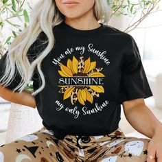 "You Are My Sunshie T-Shirt, Sunflower shirt, Sunshine tshirt, Mom Gift You'll love You are my sunshine Shirt! This classic unisex jersey short-sleeve tee fits like a well-loved favorite. Soft cotton and quality print make users fall in love with it over and over again. These t-shirts have ribbed knit collars to bolster shaping. The shoulders have taping for a better fit over time. Dual side seams hold the garment's shape for longer. UNISEX Bella + Canvas 3001 Jersey Short Sleeve Tee These shirt Relaxed Fit Short Sleeve T-shirt With Sunflower Design, Cotton T-shirt With Sunflower Design, Crew Neck Cotton T-shirt With Sunflower Design, Sunshine Shirt, Garden Shirt, Fall Shirts Women, Sunflower Shirt, Gardening Shirts, Fall Shirt