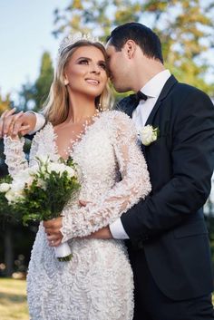 a bride and groom pose for a wedding photo