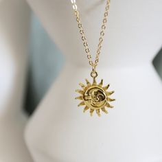 "Beautiful and lovely gold moon and sun face pendant necklace. Made of the gold plated sun and moon face pendant with a skinny gold plated brass chain. Soft and simple. Great for a gift, every day, or on a special occasion. Your item will ship in a gift box. Please feel free to contact me if you have any questions. ♥ Length 15\" - 20\" chain ♥ Pendant 5/8\" ♥ Gold plated over brass ♥ See more Rudiana Accessories Rudiana.etsy.com" Gold Moon Charm Necklace With Sun And Moon Design, Gold Charm Necklace With Sun And Moon Design Gift, Bohemian Gold Necklaces With Sun And Moon Design, Minimalist Gold Charm Necklace With Sun And Moon Design, Gold Dainty Sun Design Charm Necklace, Minimalist Gold Necklace With Sun And Moon Design, Dainty Gold Charm Necklace With Sun Design, Gold Spiritual Charm Necklace With Sun And Moon Design, Spiritual Gold Charm Necklace With Sun And Moon Design