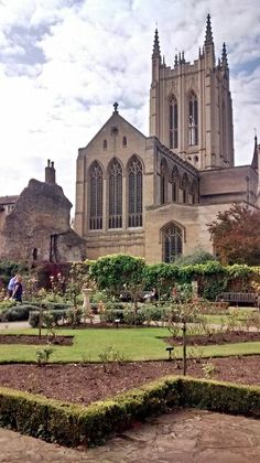 a large building with many windows and plants in the foreground