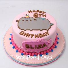 a pink birthday cake with a hippo on it