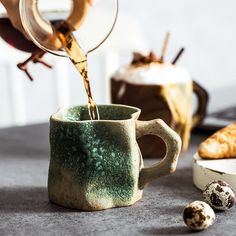 a person pours coffee into a mug