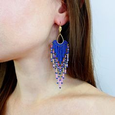 "Long beaded fringe earrings. The earrings are made of Japanese and Czech seed beads and glass beads of different shapes. All metal parts of the earring are made of stainless steel with gold plated. The total length of the earring is 9.5cm (3.7\"), width 2.5cm (1\"). The weight of one earring is 4.4g (0.2oz). The earrings are packed in a white box with a ribbon. Product care: protect from cosmetics, do not leave in direct sunlight, do not wet." Gold Beaded Dangle Chandelier Earrings, Festival Blue Chandelier Earrings With Colorful Beads, Gold Tassel Dangle Earrings With Colorful Beads, Royal Blue Beaded Earrings, Blue Earrings With Colorful Round Beads, Blue Hand-strung Round Beads Earrings, Unique Blue Beaded Earrings Nickel-free, Bead Chandelier, Beaded Chandelier Earrings