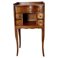 an old wooden desk with drawers on one side and a drawer on the other end