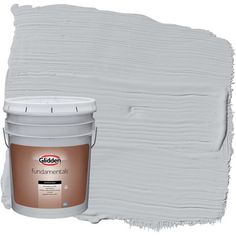 a paint can with a white bucket next to it and the color is light green