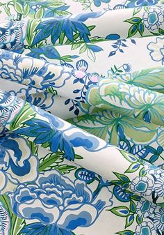 blue and green floral print on white fabric with large flowered flowers in the center