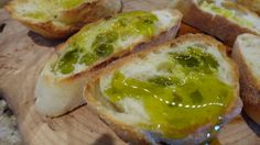 several pieces of bread with green sauce on them