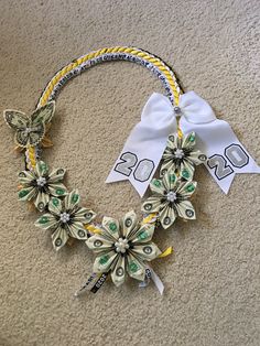 a necklace made out of dollar bills and ribbon