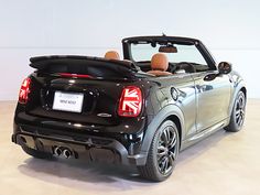 the back end of a black convertible car