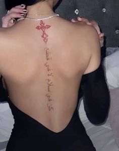 a woman with a cross tattoo on her back