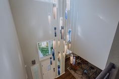 an aerial view of a staircase with lights hanging from it's sides and pictures on the wall