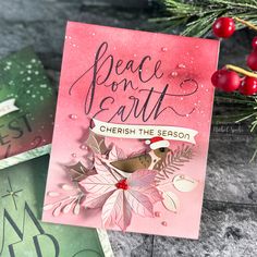 a card with the words peace and earth on it, next to some christmas decorations