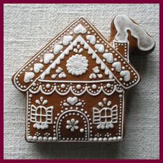 a gingerbread house decorated with white icing