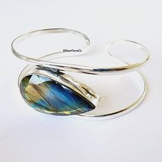 Labradorite Bangle, 925 sterling silver, Natural Labradorite, Silver Bangle, Handmade Bangle, Solver Jewelry, Women Bangle, Gift for her Benefits Of Gemstone : It helps an individual regain energy while aiding the body and spirit in healing itself. In the metaphysical world, labradorite is considered one of the most powerful protectors. The gemstone creates a shield for auras and protects against negativity of the Its energies can give you a sense of purposefulness, and it will help you develop Silver Labradorite Bangle Bracelets, Silver Labradorite Bangle Bracelet, Gemstone Bangle, Handmade Bangles, Labradorite Crystal, Third Eye Chakra, Silver Bangle, Jewelry Women, Silver Bangles