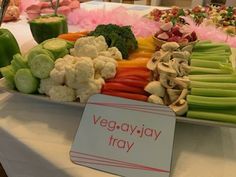 there are many different vegetables on the table with a sign that says veggay tray