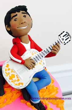 a cake that has a man with a guitar on it