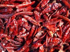 red peppers are piled up in a pile