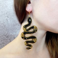 Black and gold snake earrings. Handmade earrings are made using the technique of embroidery with beads. For this, I used Czech seed beads, Japanese seed beads, crystal beads, hematite star beads, sequins, gimp wire. The reverse side of the earring is made of faux leather. Earring hooks in stainless steel with gold plated. This metal is hypoallergenic. Gold plating can wear off over time. The length of the earrings is 10.3 cm (4 inches), width 4.5 cm (1.8 inches). The weight of one earring is 7.2g (0.25oz). The earrings are packed in a beautiful gift box, as in the last photo. Product care: protect from cosmetics, do not leave in direct sunlight, do not wet. Store in a separate box. For this, the box in which the earrings are sold is suitable. I can make such earrings in a different color. Gold Snake Earrings, Faux Leather Earring, Embroidery With Beads, Star Beads, Leather Earring, Evil Eye Earrings, Snake Earrings, Eye Earrings, Gold Snake