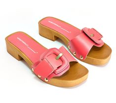 An absolute summer hit, these clog sandals feature an elegant wood-like base and large upper buckle for a statement style piece. From INTENTIONALLY BLANK. Summer Beach Clogs With Buckle Closure, Chic Spring Clogs With Buckle Closure, Summer Buckle Closure Open Heel Clogs, Trendy Beach Clogs With Wooden Heel, Chic Clogs With Wooden Heel For Beach, Chic Beach Clogs With Wooden Heel, Chic Summer Clogs With Buckle Closure, Intentionally Blank, Clog Sandals