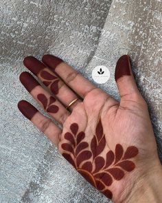 a person's hand with hennap on it, showing the shape of leaves