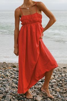 The Marigold Smocked Maxi Dress features a stretchy smocked top and full length design in a vibrant cherry red. Perfect for both casual and formal occasions, this dress is sure to make a statement and keep you feeling chic and confident all day long. Summer Red Outfits, Casual Red Dress, Boat Attire, Flowy Red Dress, Vietnam Clothes, Red Dress Casual, Luau Outfits, Maternity Lounge Wear, Red Linen Dress