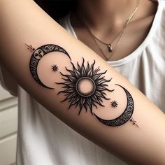 a woman's arm with a sun and moon tattoo on it